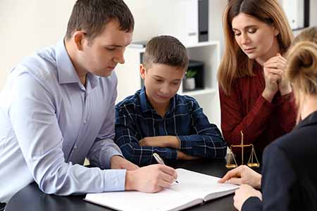 Divorced parents with their son visiting lawyer. Concept of child support